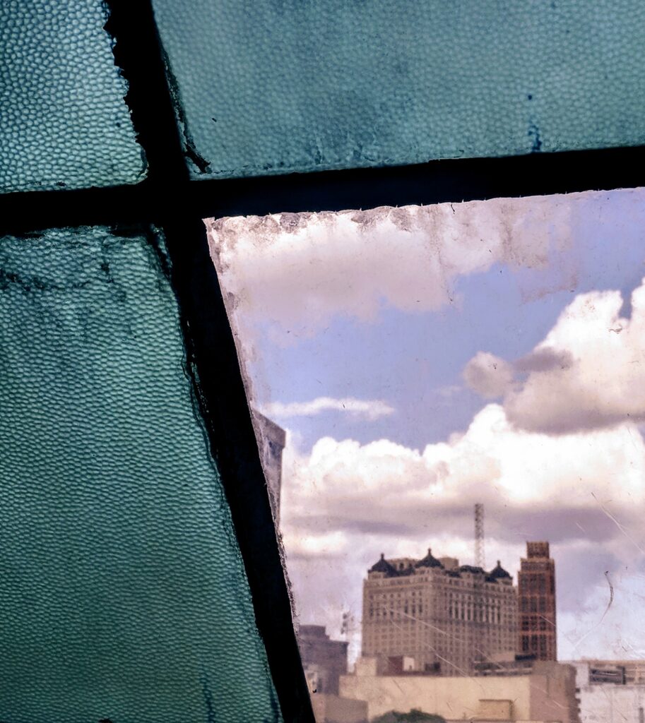 Photo of a building through a blue glass window