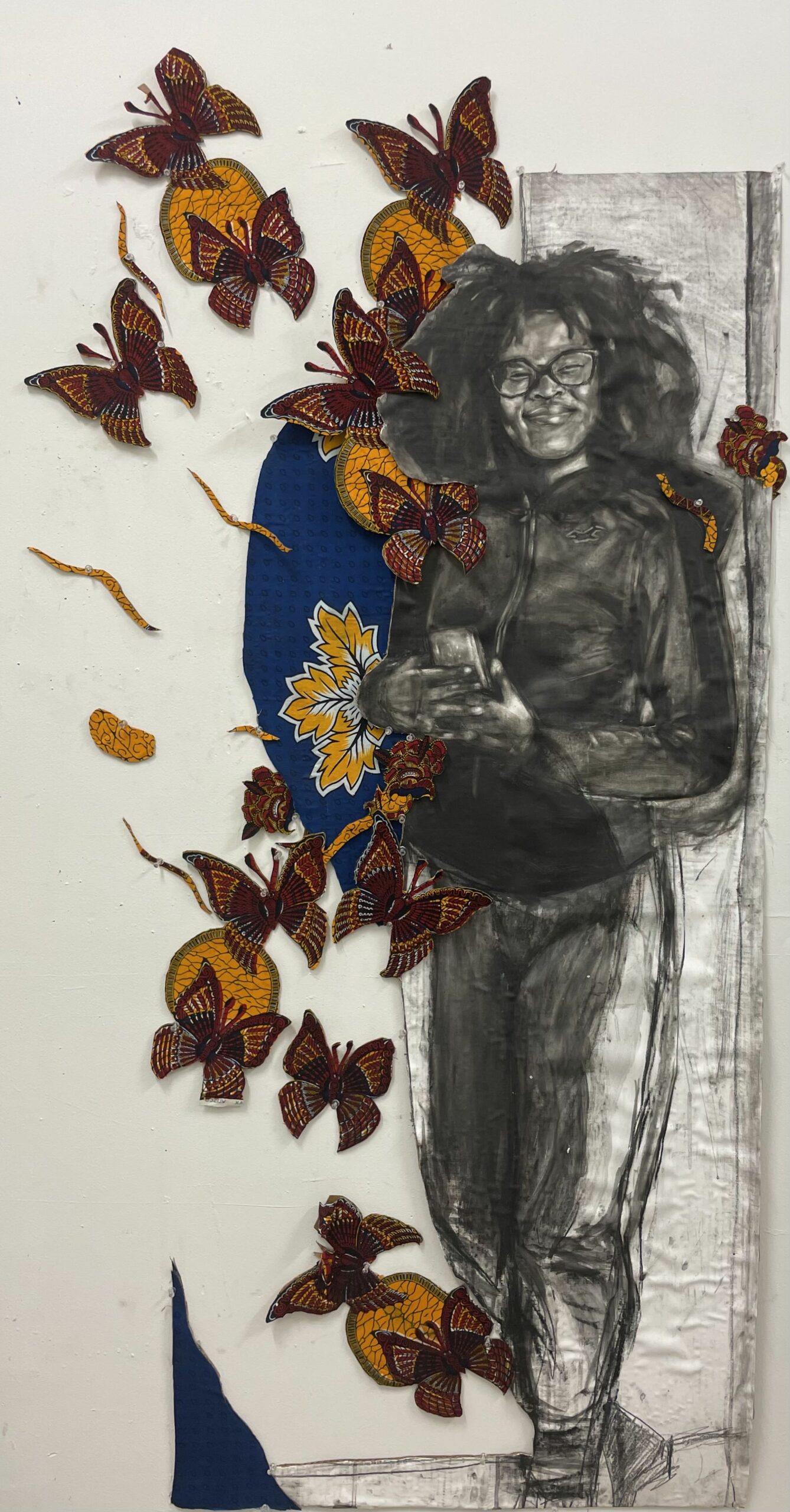 A charcoal drawing of a woman in athletic clothes surrounded by orange and yellow butterflies